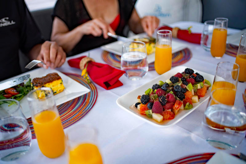 Yacht charter blog - catamaran Aquamania breakfast with mimosas